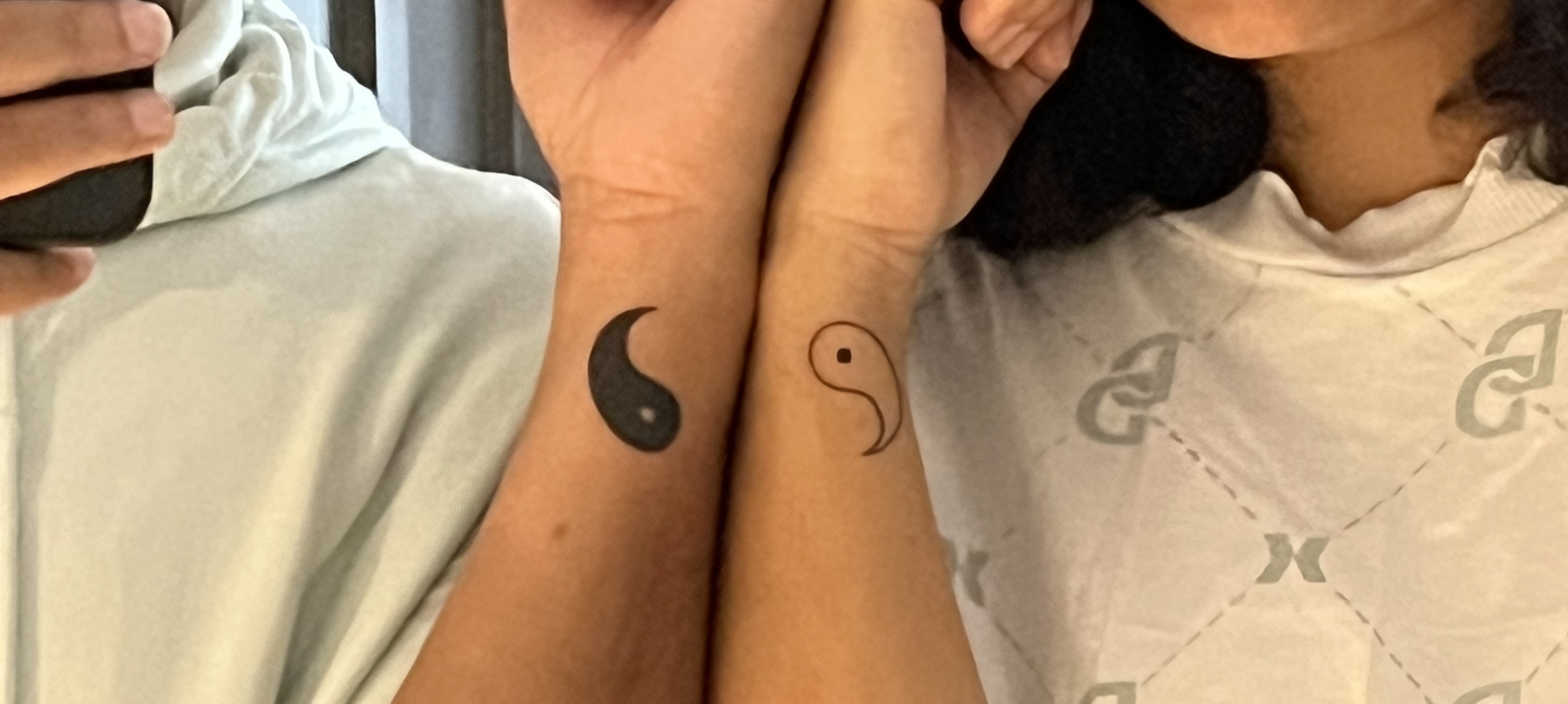 Matching yin-yang tattoos